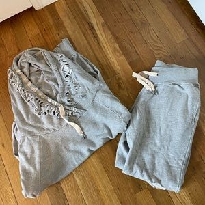 Grey sweatshirt and sweatpants set.